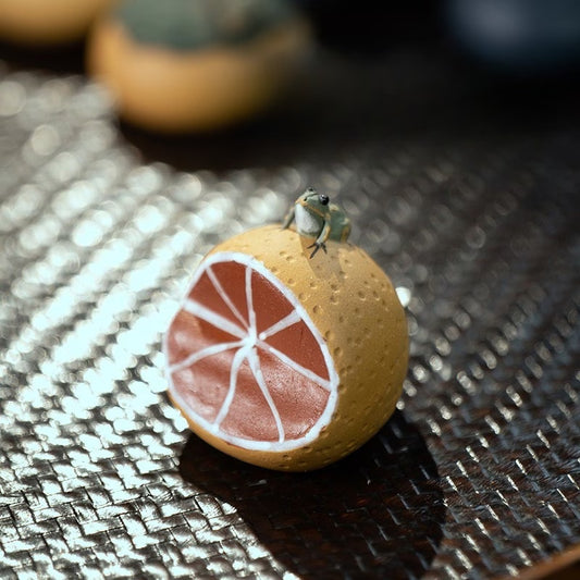 Water Spraying Frog on Orange